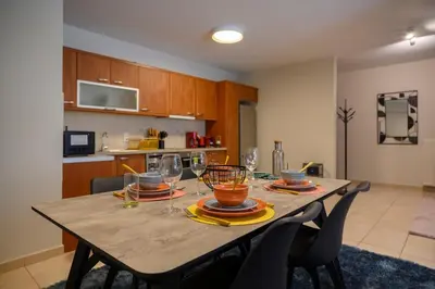 a dining table with wine glasses on it in a kitchen at Artistic 2bedroom Luxury Hop to Acropolis in Athens