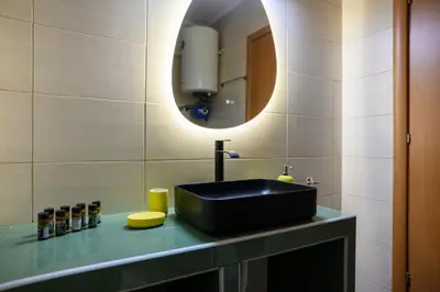 a bathroom with a black sink and a mirror at Artistic 2bedroom Luxury Hop to Acropolis in Athens