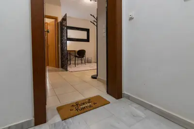 a hallway with a welcome mat on the floor at Artistic 2bedroom Luxury Hop to Acropolis in Athens