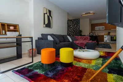 a living room with a couch and a colorful rug at Artistic 2bedroom Luxury Hop to Acropolis in Athens