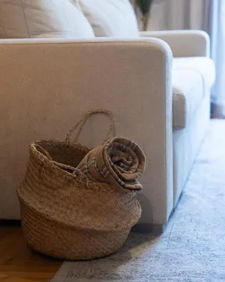 a basket sitting on the floor next to a couch at 65m2 Apt 10 min on Foot From Acropolis in Athens