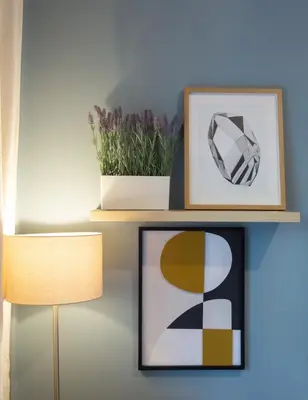 a shelf with two plants and a picture and a lamp at 65m2 Apt 10 min on Foot From Acropolis in Athens