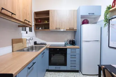 a kitchen with a white refrigerator and a sink at 65m2 Apt 10 min on Foot From Acropolis in Athens