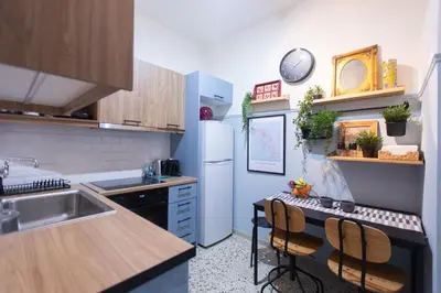 a kitchen with a sink and a white refrigerator at 65m2 Apt 10 min on Foot From Acropolis in Athens