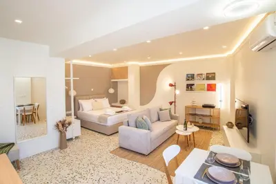 a living room with a couch and a table at Queen Mary Psyri in Athens