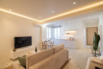 a living room with a large couch and a television at Queen Mary Psyri in Athens
