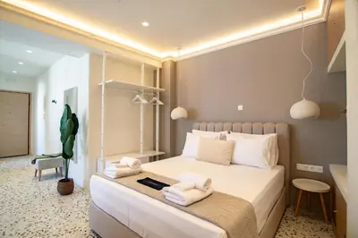 a bedroom with a bed with towels on it at Queen Mary Psyri in Athens