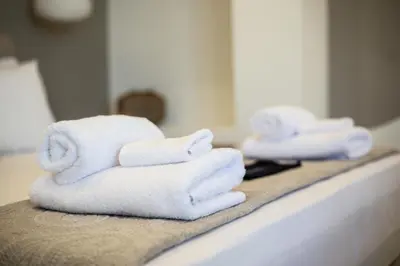 a pile of towels sitting on a bathroom counter at Queen Mary Psyri in Athens