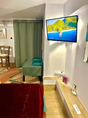 a room with a flat screen tv on a wall at Chic & Cozy Apartment in Gazi, Athens in Athens