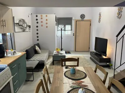 a living room with a couch and a table at Chic & Cozy Apartment in Gazi, Athens in Athens