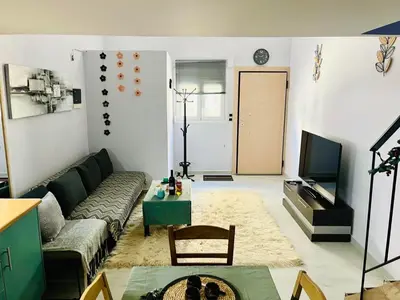 a living room with a couch and a table at Chic & Cozy Apartment in Gazi, Athens in Athens