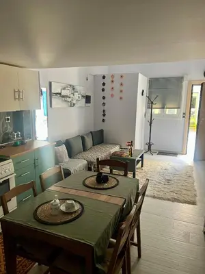 a kitchen and a living room with a table and chairs at Chic & Cozy Apartment in Gazi, Athens in Athens
