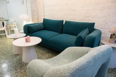 a living room with a blue couch and two tables at 3Bed Loft 500m from Monastiraki Sq in Athens