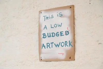 a sign on a wall that says this is a low colored art work at 3Bed Loft 500m from Monastiraki Sq in Athens
