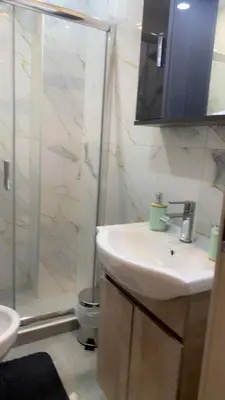 a bathroom with a sink and a shower at Kallithea Rent in Athens