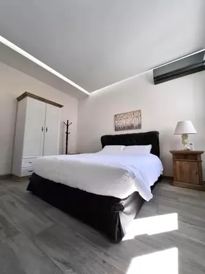 a bedroom with a large bed with white sheets at Cube House in Athens