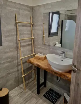 a bathroom with a sink and a mirror at Cube House in Athens