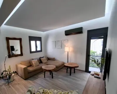 a living room with a couch and a table at Cube House in Athens