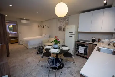 a kitchen and living room with a table and chairs at Pixie Studio Athens in Athens