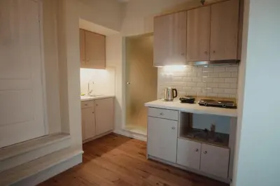a kitchen with white cabinets and a stove top oven at Andromeda 102 apartments in Spáta