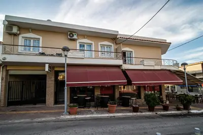 a building on the corner of a street at Andromeda 102 apartments in Spáta