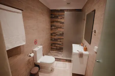 a bathroom with a toilet and a sink at Andromeda 102 apartments in Spáta