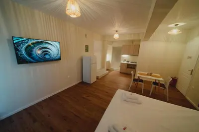 a living room with a table and a painting on the wall at Andromeda 102 apartments in Spáta