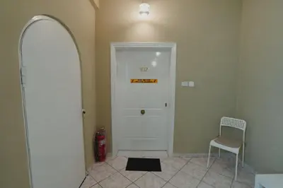 a hallway with a white door and a chair at Andromeda 102 apartments in Spáta