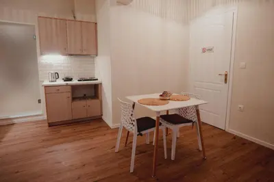 a small kitchen with a table and two chairs at Andromeda 102 apartments in Spáta