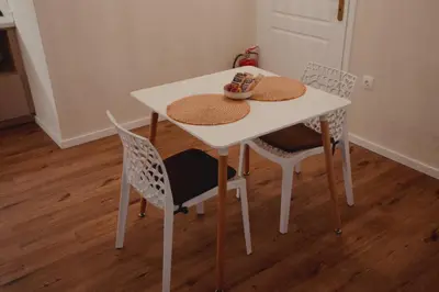 a white table and chairs with hats on it at Andromeda 102 apartments in Spáta