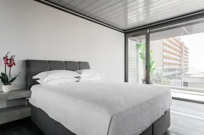 a bedroom with a bed and a large window at Raise Infinity Blue Penthouse in Athens