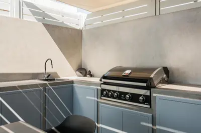 a kitchen with a stove and a sink at Raise Infinity Blue Penthouse in Athens