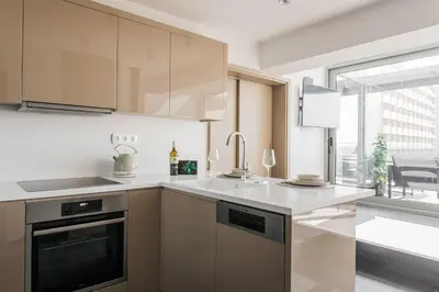 a kitchen with stainless steel appliances and a window at Raise Infinity Blue Penthouse in Athens
