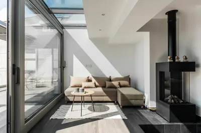 a living room with a couch and a fireplace at Raise Infinity Blue Penthouse in Athens