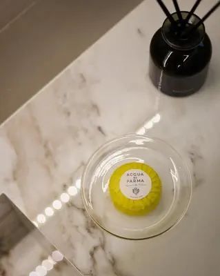 a cupcake sitting on a glass plate on a counter at Margie Luxury suite in Athens