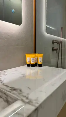 three yellow cups sitting on a counter in a bathroom at Margie Luxury suite in Athens