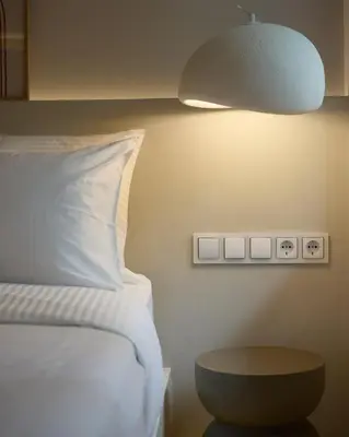 a bedroom with a bed and a table and a lamp at Margie Luxury suite in Athens