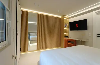 a bedroom with a large white bed and a mirror at Margie Luxury suite in Athens
