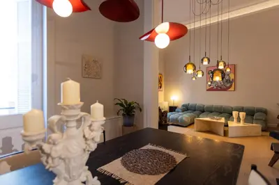 a living room with a table and a couch at Theion Estate - A Blend of Art & Architecture in Athens Center by etouri in Athens