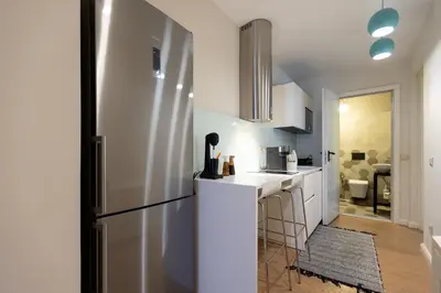 a kitchen with a refrigerator and a counter top at Theion Estate - A Blend of Art & Architecture in Athens Center by etouri in Athens
