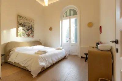 a bedroom with a large white bed and a window at Theion Estate - A Blend of Art & Architecture in Athens Center by etouri in Athens