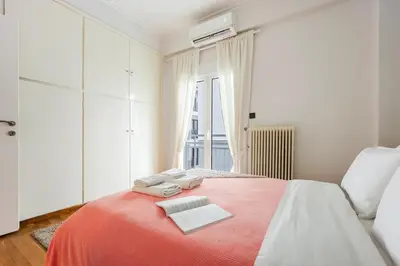 a bedroom with a red bed with towels on it at Cozy Pangrati Hideaway in Athens