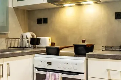 a kitchen with a stove with two pots on it at Cozy Pangrati Hideaway in Athens