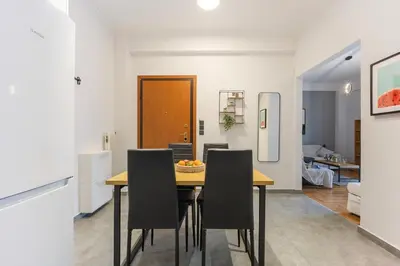 a kitchen and dining room with a table and chairs at Cozy Pangrati Hideaway in Athens