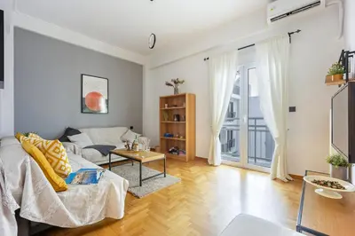 a living room with a couch and a table at Cozy Pangrati Hideaway in Athens