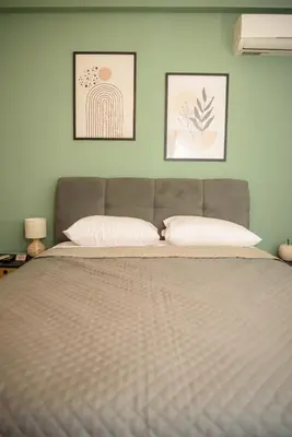 a bedroom with a large bed with two pillows at Modern Flat in Exarchia in Athens
