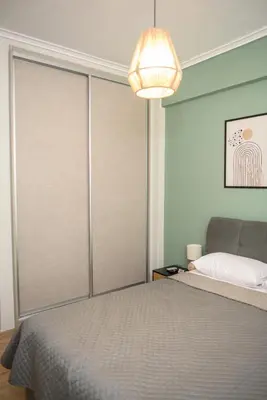 a bedroom with a bed with sliding glass doors at Modern Flat in Exarchia in Athens