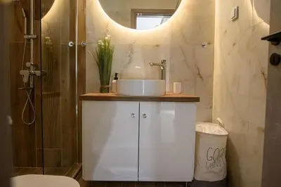 a bathroom with a white sink and a shower at Modern Flat in Exarchia in Athens