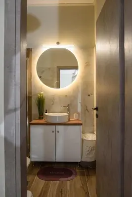 a bathroom with a sink and a mirror at Modern Flat in Exarchia in Athens