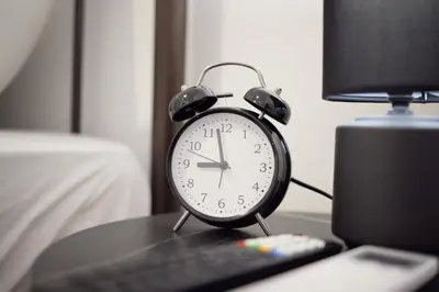 an alarm clock sitting on a table next to a keyboard at ARIS Central Kallithea in Athens